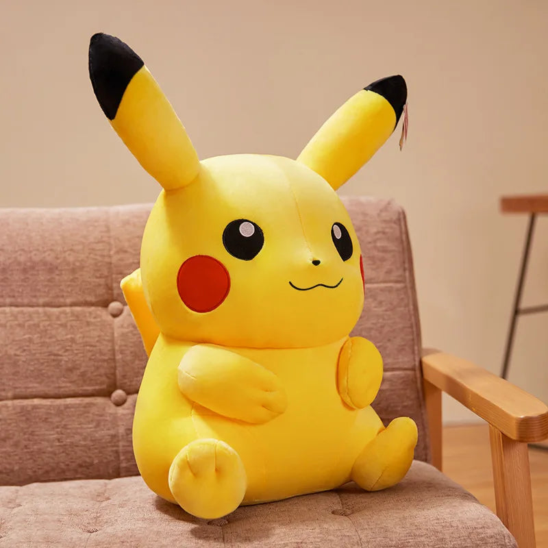 Large Pikachu plush toy sitting on a chair with a neutral background