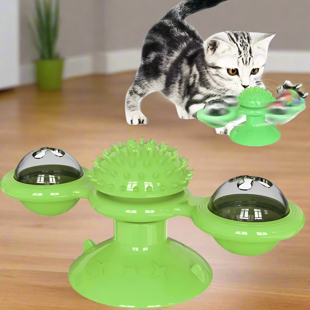 Green cat toy with rotating bowls and spike top, accompanied by a cat