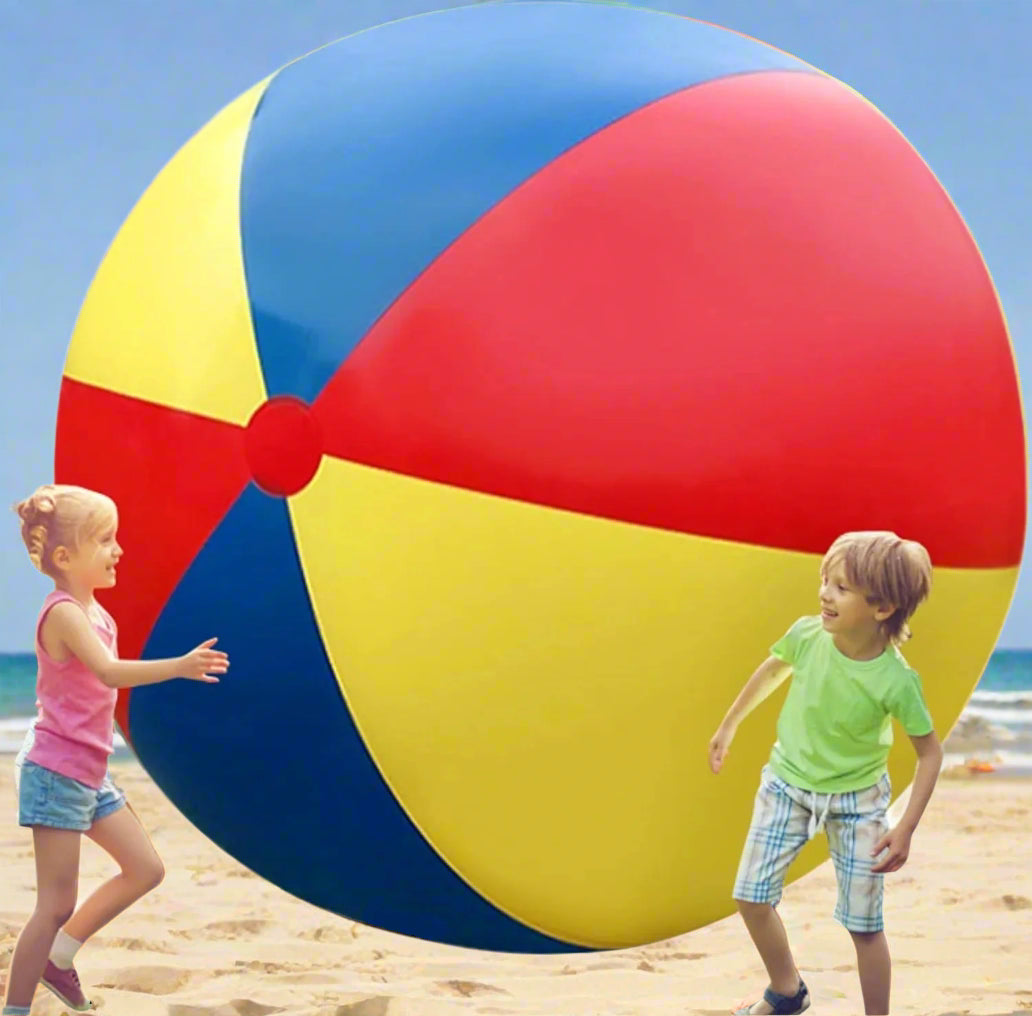 Two children playing with a large colorful beach ball