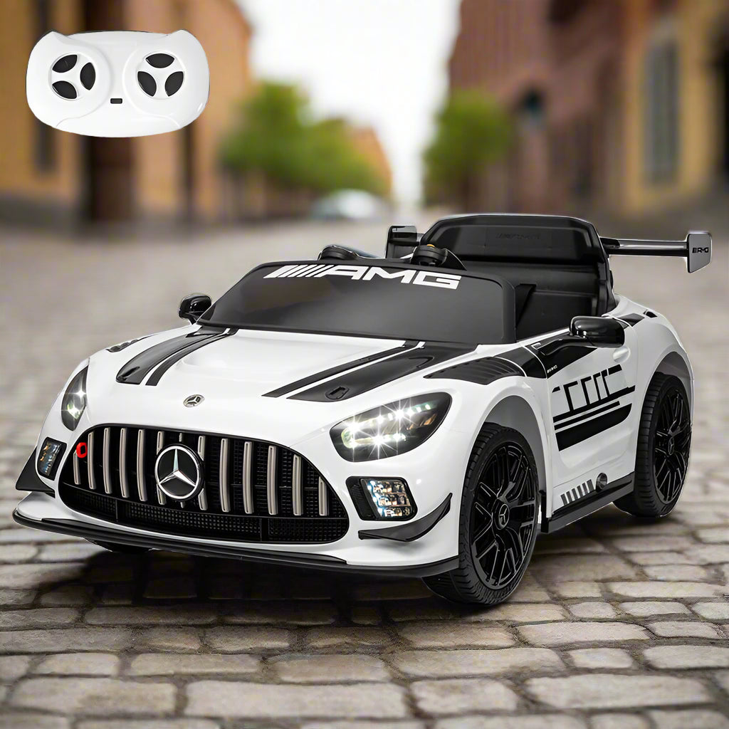 White and black toy car with Mercedes-Benz logo and remote control on a white background