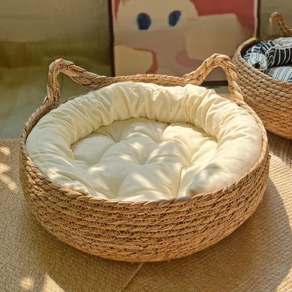 Woven pet bed with a soft cream cushion inside, placed on a textured surface.