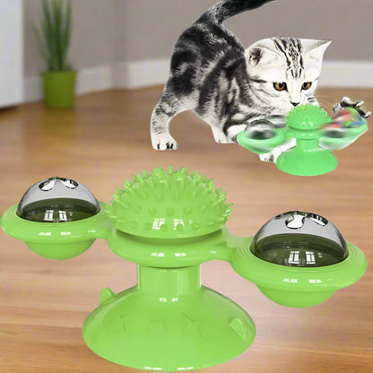 Green cat toy with rotating bowls and spike top, accompanied by a cat