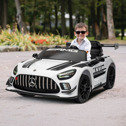Child sitting in a toy Mercedes-Benz car outdoors