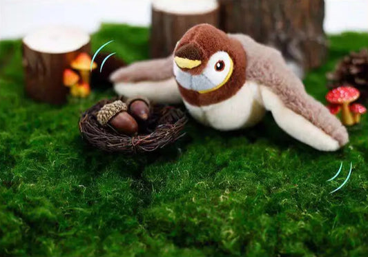Plush toy bird with a nest and eggs on a green grass-like surface